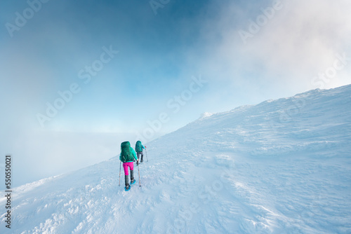 two girls climb the mountain.