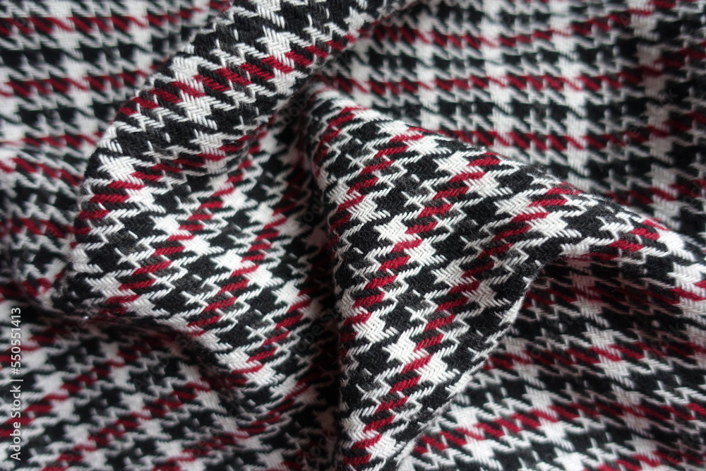 Draped thick black, red and white woolen twill fabric Draped thick black, red and white woolen twill fabric