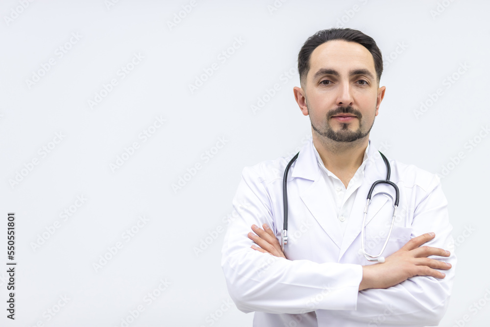 Photo of male mature doctor posing at camera with a stethoscope. Photo of male mature doctor posing at camera with a stethoscope.