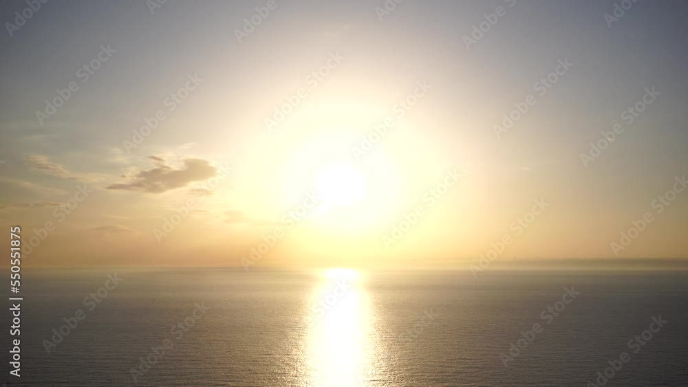 Abstract nature summer or spring ocean sea background. Small waves on golden warm water surface in motion blur with bokeh lights from sunrise. Holiday, vacation and recreational background concept Abstract nature summer or spring ocean sea background. Small waves on golden warm water surface in motion blur with bokeh lights from sunrise. Holiday, vacation and recreational background concept