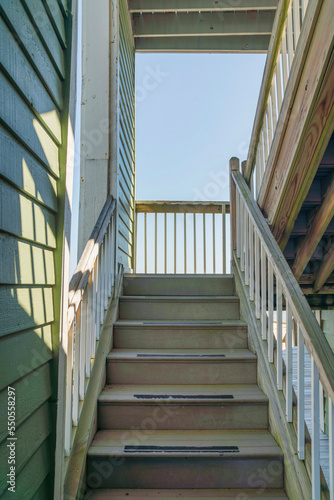 Navarre  Florida- Narrow staircase near the wall with painted wood lap sidings