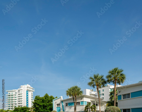 Views of white buildings with trees outdoors under the clear blue sky at Miami, Florida