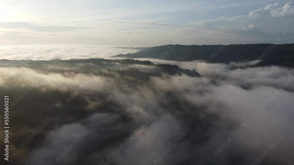 Drone flying over cloud in the morning. Aerial view of Indonesia mountains Drone flying over cloud in the morning. Aerial view of Indonesia mountains