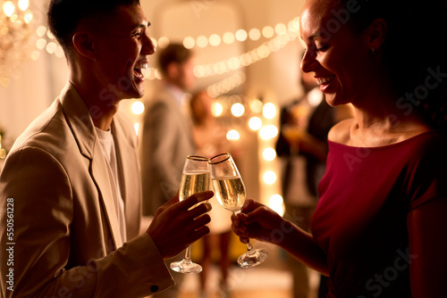 Close Up Of Couple At Party Making Champagne Toast Together