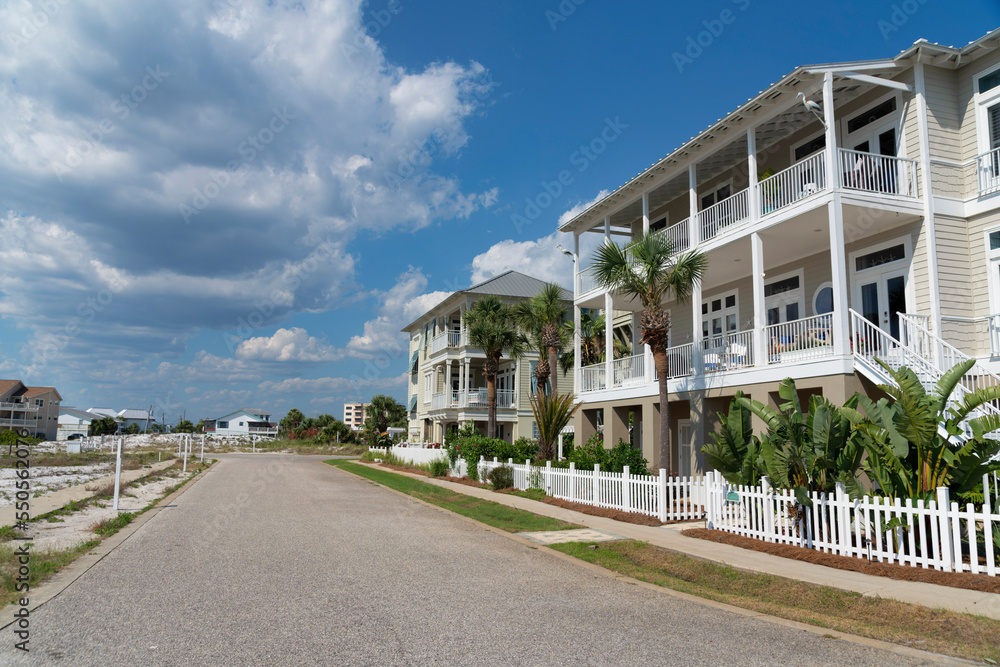 Destin, Florida- Street with concrete road at the front of three-storey houses with terrace Destin, Florida- Street with concrete road at the front of three-storey houses with terrace