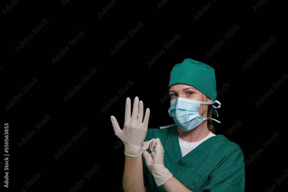 Doctor surgeon preparing makes an operation. Isolated on a black background. Doctor surgeon preparing makes an operation. Isolated on a black background.