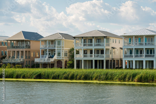 Destin, Florida- Row of three-storey houses with view decks and lake waterfront