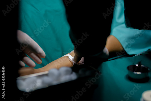 A nurse is preparing a patient before surgery being given saline solution.