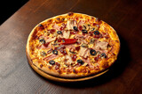 Italian pizza with ham, cheese and olives on a wooden board. Italian cuisine. Close-up