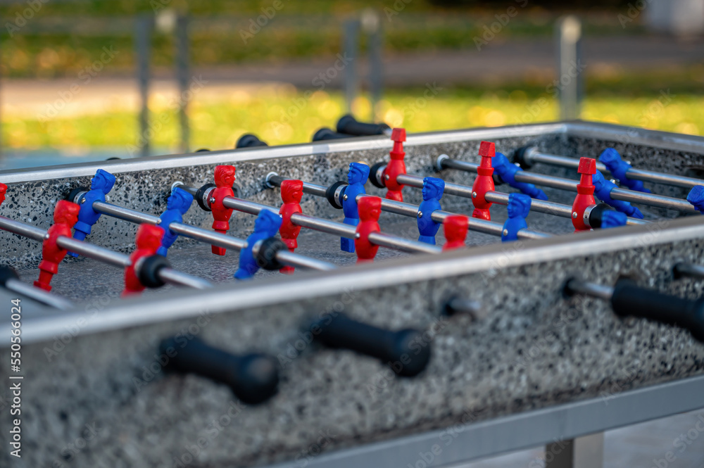 Obraz premium outdoor football table to play football with red and blue players, close up