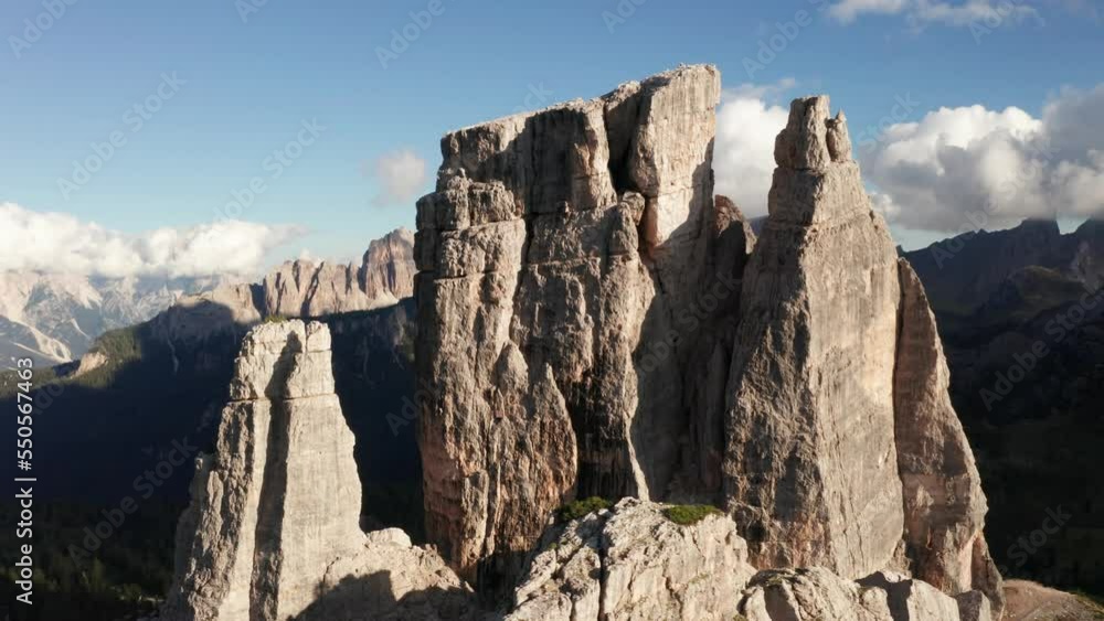 Close aerial view of iconic Cinque Torri mountain spires with Croda da Lago in background - rugged Dolomite landscape in Italy Close aerial view of iconic Cinque Torri mountain spires with Croda da Lago in background - rugged Dolomite landscape in Italy