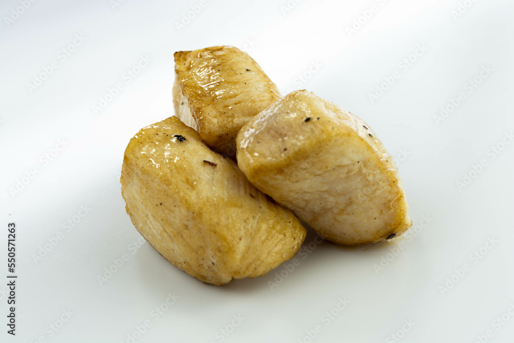 fresh baked chicken cubes on white background fresh baked chicken cubes on white background
