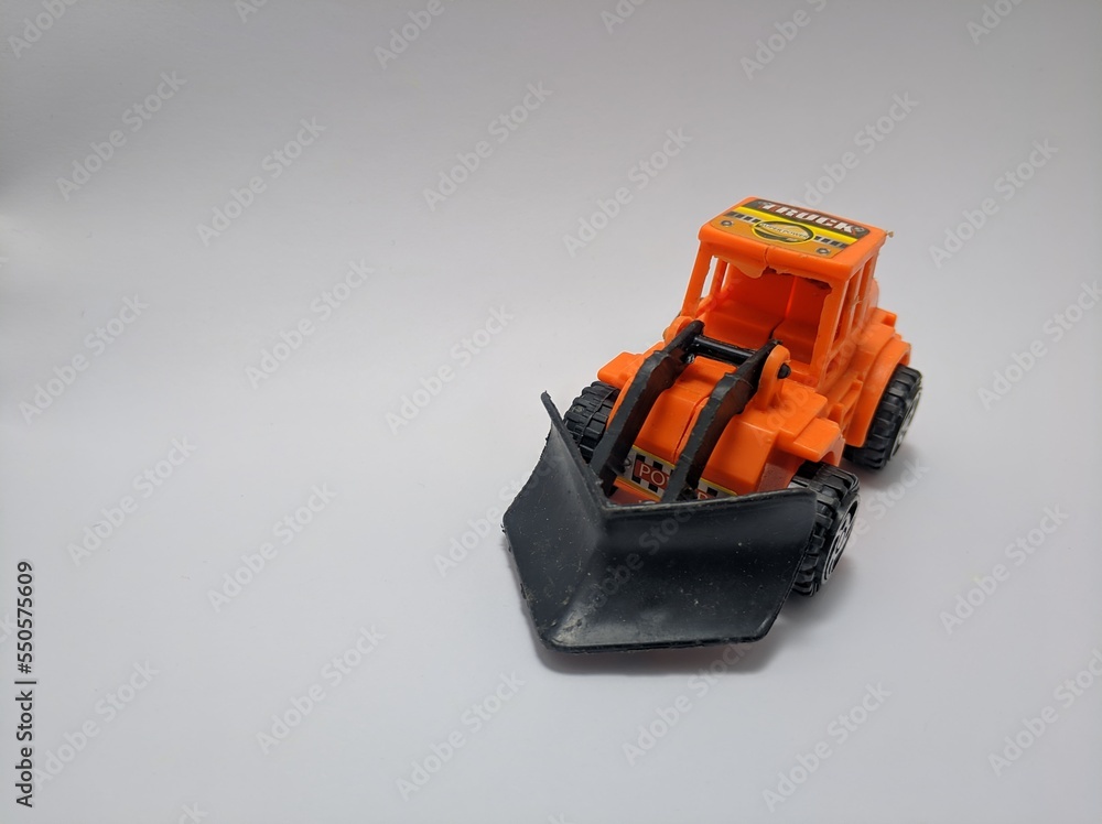 Fototapeta premium Close up view of shovel nose tractor toys made from plastic isolated on white background.