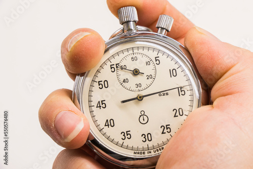 Old antiquary timer clock and humans hand photo