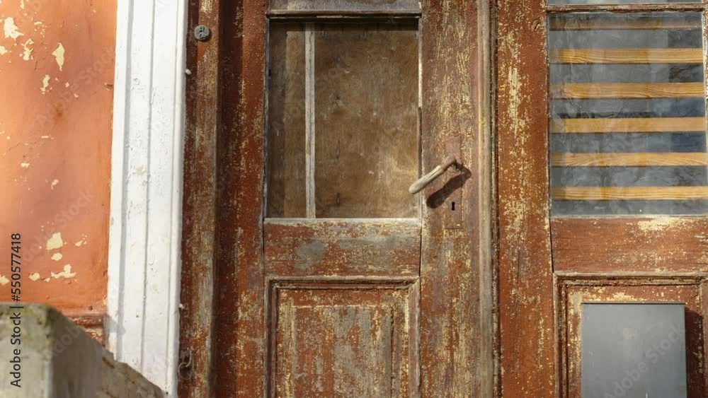 The red door of the abandoned house that is already ruined and broken in Estonia The red door of the abandoned house that is already ruined and broken in Estonia