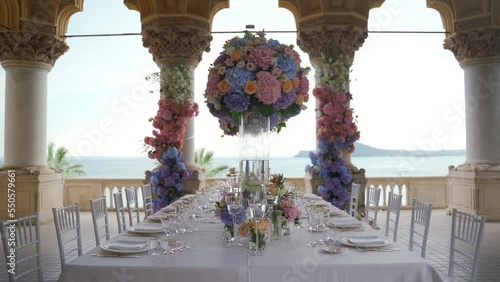 Wedding table decorated with flowers with the sea view, Italy