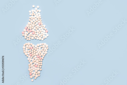 World osteoporosis day. Human  joints and bone made of pills on blue background