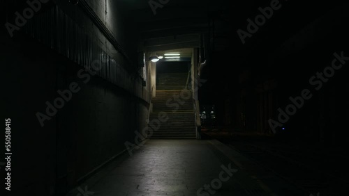 Abandoned railway / subway platform. Ghetto. Rainy autumn foggy weather in the night city. Gotham city mood. Cinematic style. Dungeon columns and dim light. Graffiti on the walls. Concrete stairs