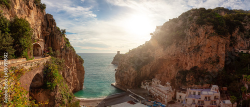 Fototapeta Naklejka Na Ścianę i Meble -  Sandy Beach on the Rocky Coast on Sea. Marina di Praia, Praiano, Amalfi Coast, Italy. Sunset Sky