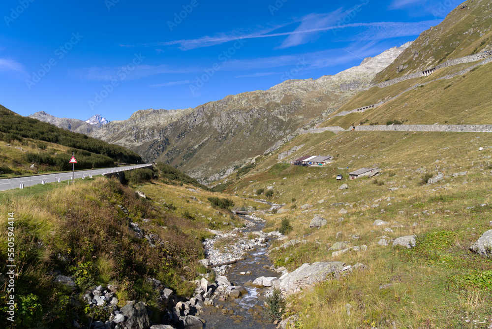 Fototapeta premium Scenic view of famous Swiss mountain pass Furkapass with rocks and mountain peak on a sunny late summer day. Photo taken September 12th, 2022, Furka Pass, Switzerland.