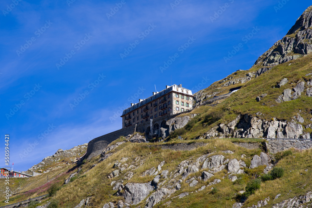 Scenic view of famous Swiss mountain pass Furkapass with serpentine road and Bélvedère Hotel on a sunny late summer day. Movie shot September 12th, 2022, Furka Pass, Switzerland.