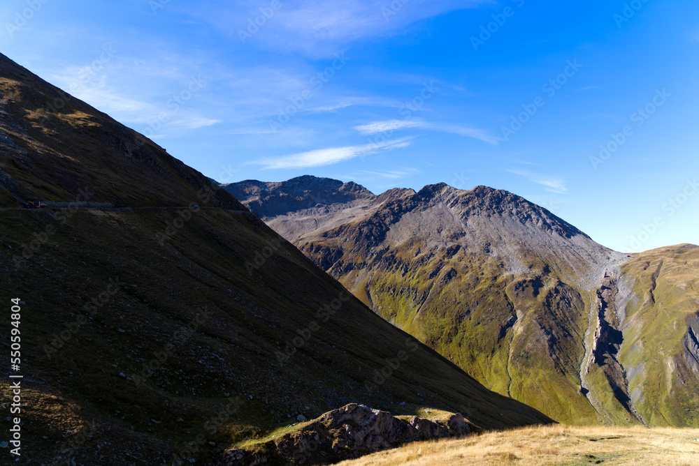 Scenic view of famous Swiss mountain pass Furkapass with rocks and mountain peak on a sunny late summer day. Photo taken September 12th, 2022, Furka Pass, Switzerland. Scenic view of famous Swiss mountain pass Furkapass with rocks and mountain peak on a sunny late summer day. Photo taken September 12th, 2022, Furka Pass, Switzerland.
