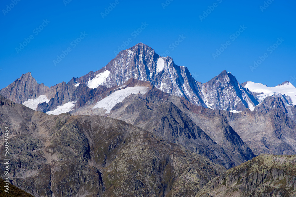 Impressive panoramic landscape in the Swiss Alps with peak Finsteraarhorn at region of Swiss mountain pass Furkapass on a sunny day. Photo taken September 12th, 2022, Furka Pass, Switzerland.
