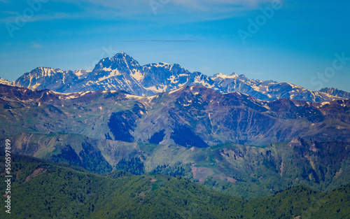 View on the snow covered Pyrenees mountains range from the summit of Tuc de l'étang in the south of France near Mourtis ski resort
