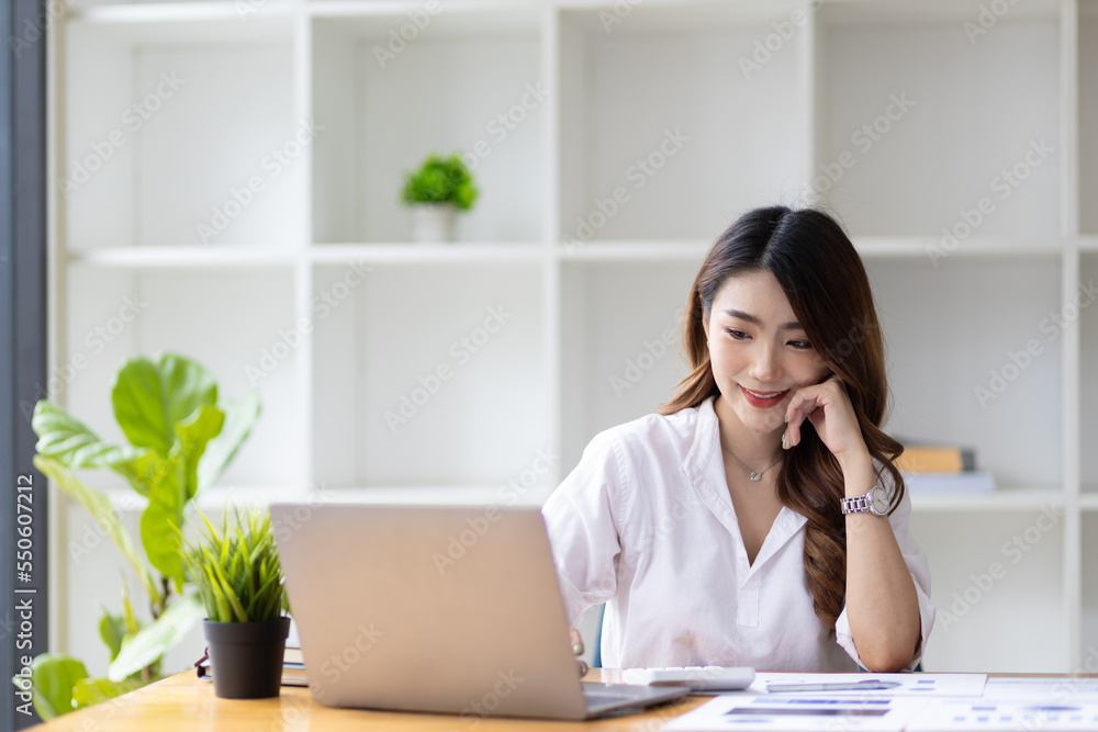 Businesswoman working in accounting with laptop in office analyzing business reports and planning financial budgets. Businesswoman working in accounting with laptop in office analyzing business reports and planning financial budgets.