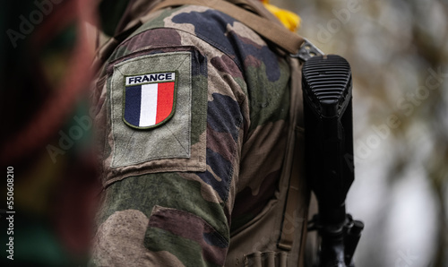 France Army soldiers uniform. Close up photo with the France flag on a military soldier uniform with the gun next to it. Military industry concept photo. photo