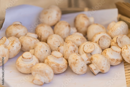 Fresh vegetables background. Champignon mushroom background. Basket of champignon mushrooms.