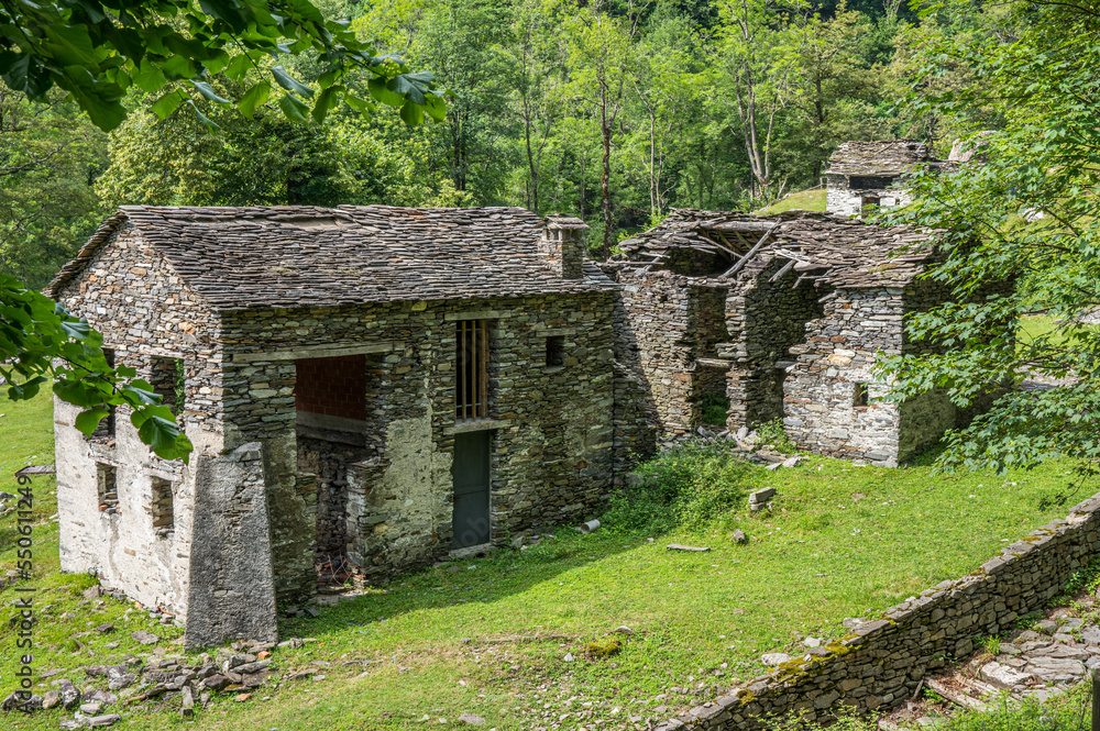 Ruined stone houses and mills in an abandoned mountain village in the Alps Ruined stone houses and mills in an abandoned mountain village in the Alps