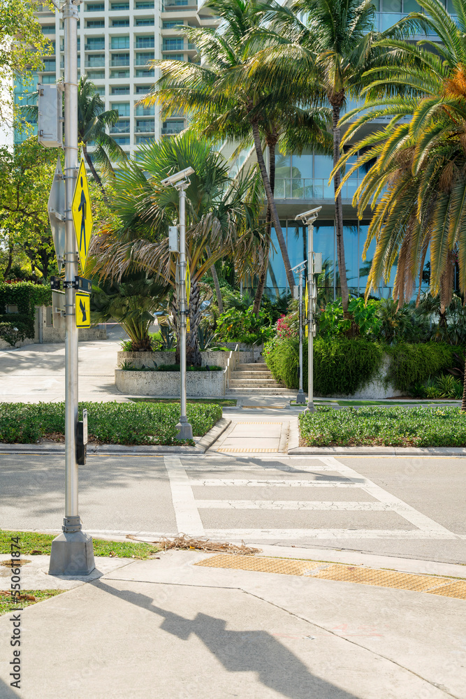 Obraz premium Crosswalk with yellow signs on the post at the side in Miami, Florida