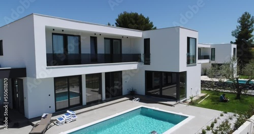 Aerial drone shot of two identical vacation homes or villas with sea view.  photo