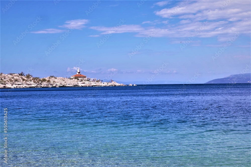 Lighthouse by the blue sea with wide horizon Lighthouse by the blue sea with wide horizon