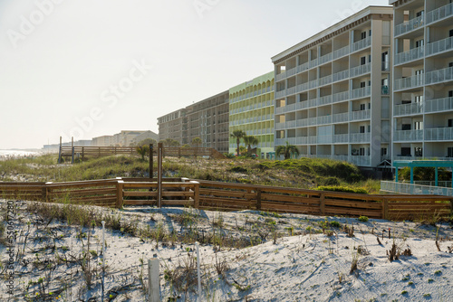 Hotel buildings with wood pathways on a white sand dunes outdoors in Destin, Florida