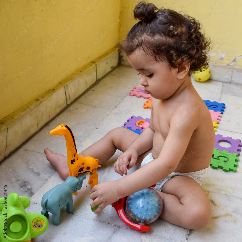 Fototapeta premium Cute little boy Shivaay Sapra at home balcony during summer time, Sweet little boy photoshoot during day light, Little boy enjoying at home during photo shoot
