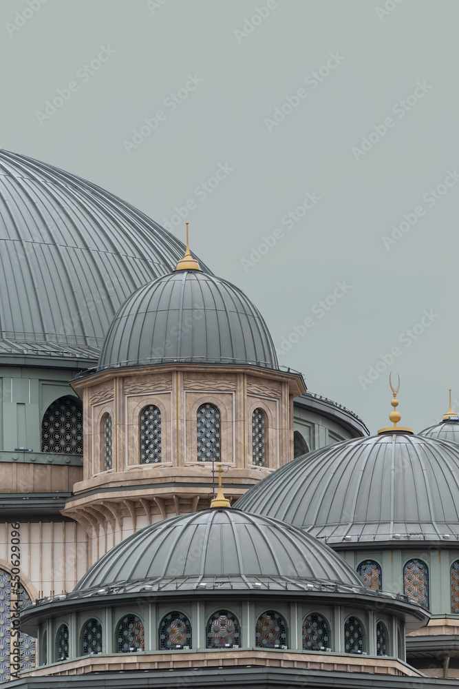 Istanbul, Turkey (Turkiye). Taksim Mosque (Taksim Camii). Mosque complex at Taksim Square at rainy cloudy day. Close up fragment. Isolated, solid color background