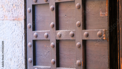 antique wooden door with metal iron reinforcements