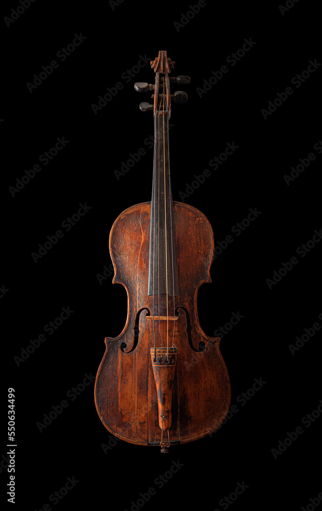 Antique violin isolated on a black background.