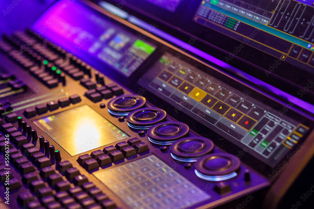 Professional stage light control panel in purple light.