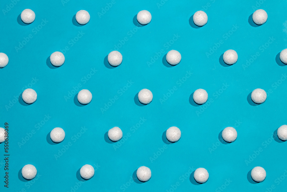 Winter pattern with snowballs on blue background. Minimal holiday concept.
Winter pattern with snowballs on blue background. Minimal holiday concept.