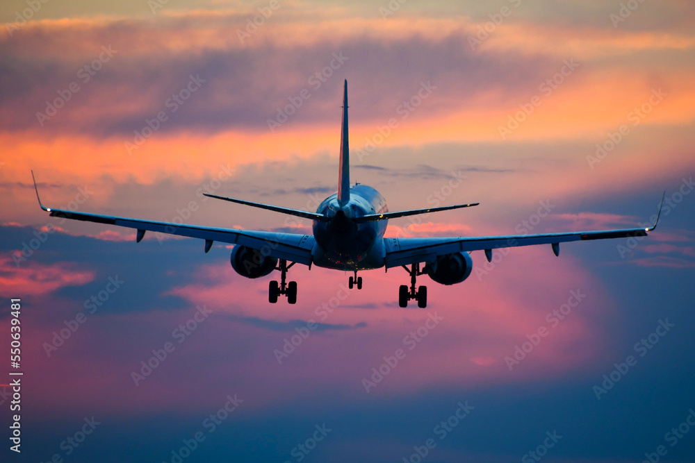 airplane landing at sunset airplane landing at sunset