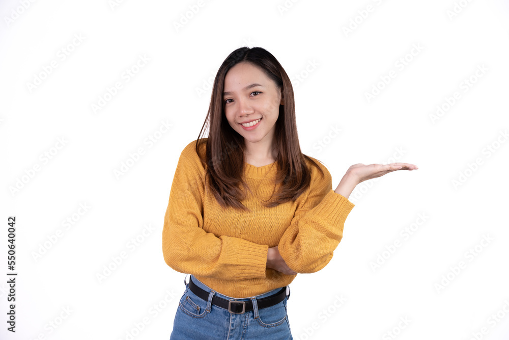 Young asian woman with yellow sweater over isolated white background pointing finger to the side. Young asian woman with yellow sweater over isolated white background pointing finger to the side.