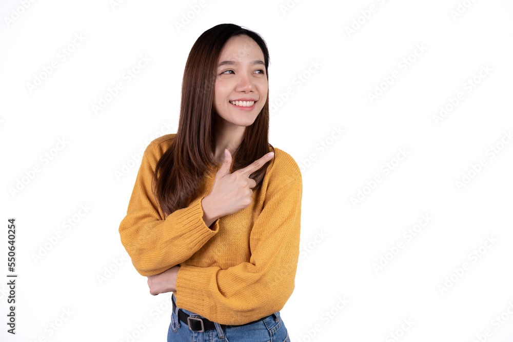 Young beautiful smiling good mood positive girl pointing finger in copyspace isolated on white background. Young beautiful smiling good mood positive girl pointing finger in copyspace isolated on white background.