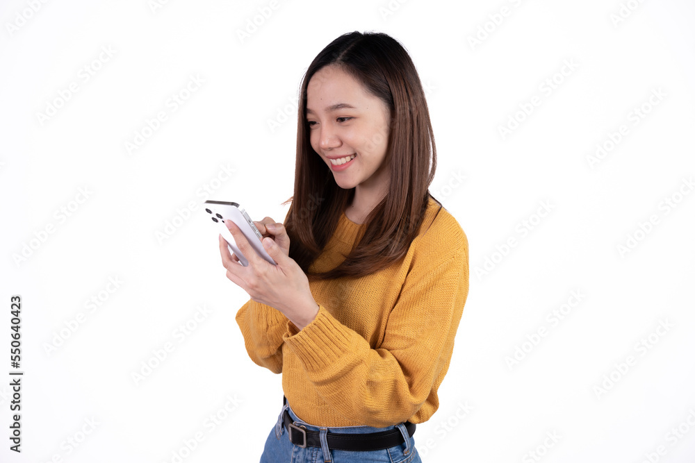 Portrait of a smiling casual asian woman holding smartphone over white background. Portrait of a smiling casual asian woman holding smartphone over white background.