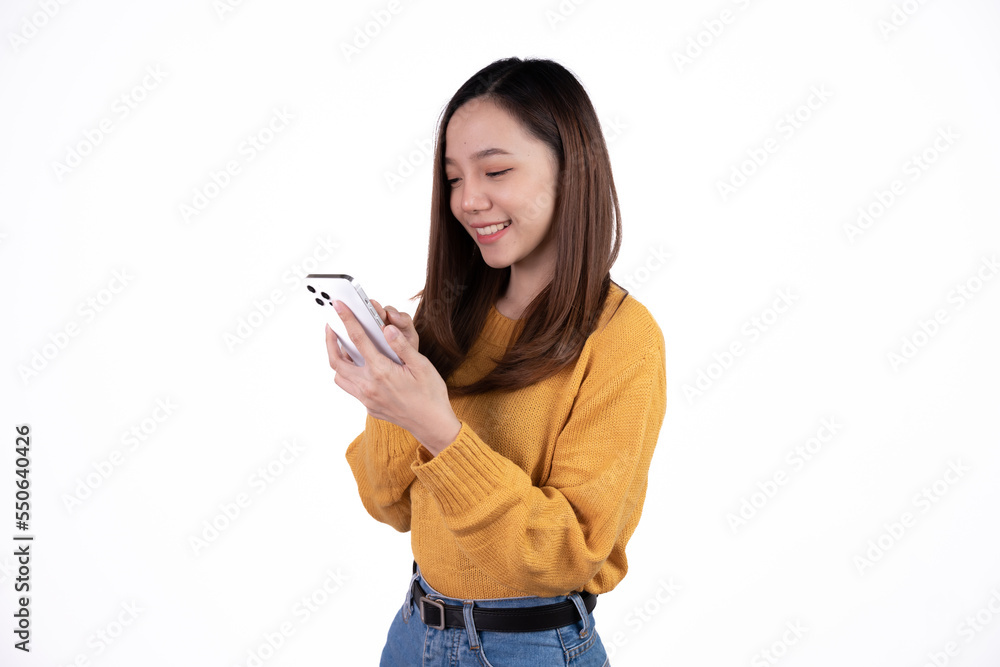 Portrait of a smiling casual asian woman holding smartphone over white background. Portrait of a smiling casual asian woman holding smartphone over white background.