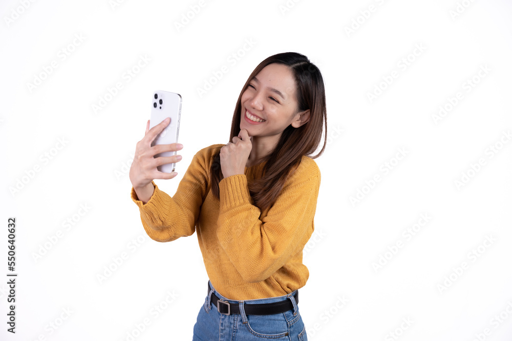 Portrait of a smiling casual asian woman holding smartphone over white background. Portrait of a smiling casual asian woman holding smartphone over white background.