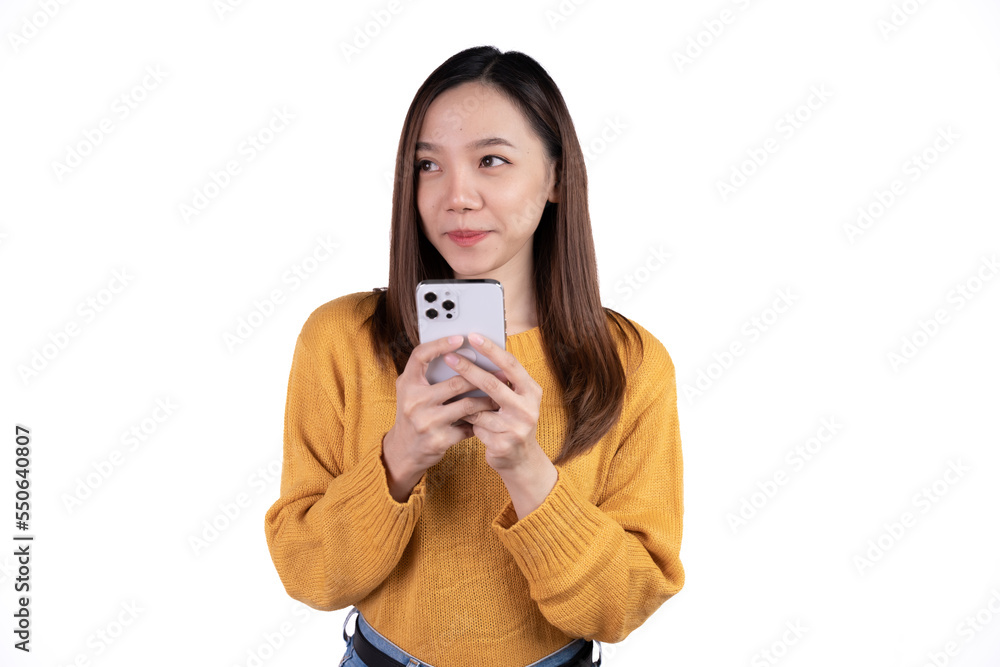 Portrait of a smiling casual asian woman holding smartphone over white background. Portrait of a smiling casual asian woman holding smartphone over white background.
