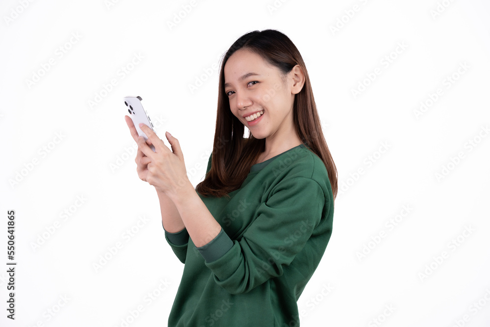 Portrait of a smiling casual asian woman holding smartphone over white background. Portrait of a smiling casual asian woman holding smartphone over white background.